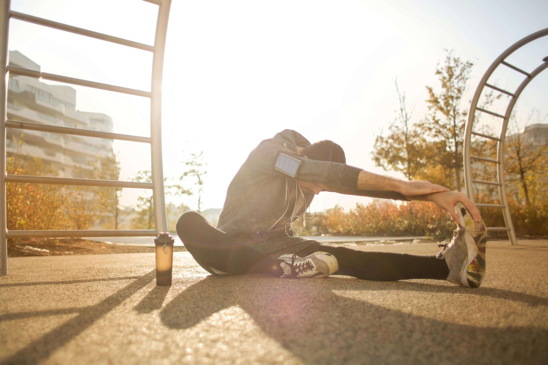 A person sitting on the ground with legs stretched out