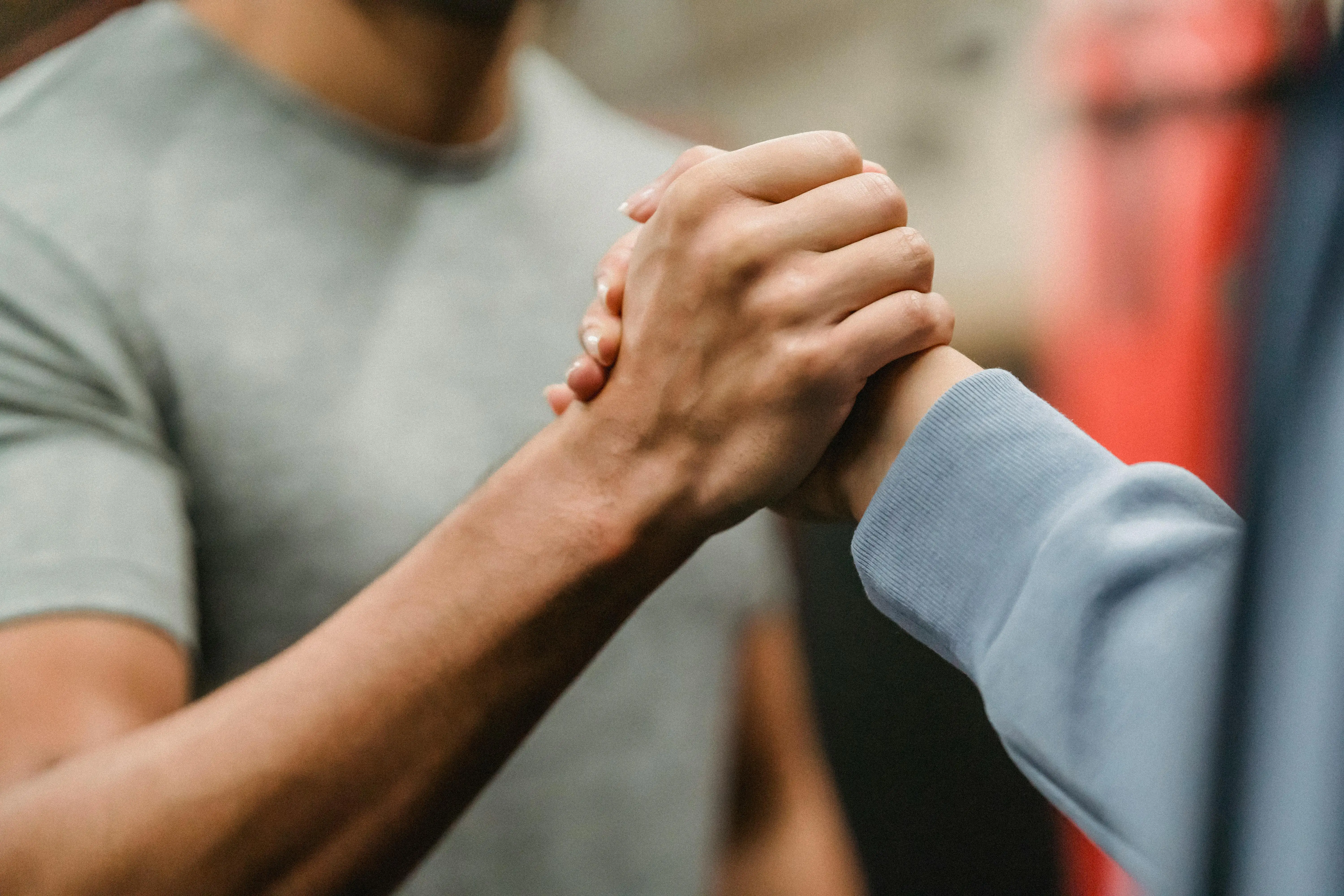 A handshake between two individuals in a gym